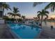 Inviting pool area with patio seating, landscaping, and waterfront views, ideal for relaxation and entertainment by the water at 533 Lillian Dr, Madeira Beach, FL 33708