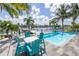 Relax in the pool area with comfortable seating, set against a stunning waterfront backdrop, ideal for outdoor living at 533 Lillian Dr, Madeira Beach, FL 33708