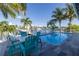 Beautiful backyard pool with waterfront views, complemented by cozy seating, landscaping, and dock access for relaxation at 533 Lillian Dr, Madeira Beach, FL 33708