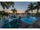 Beautiful waterfront property featuring a pool and outdoor seating for enjoying the sunset at 533 Lillian Dr, Madeira Beach, FL 33708