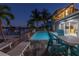 Relax by the refreshing pool with lounge chairs and outdoor seating, overlooking the intercoastal waterway at 533 Lillian Dr, Madeira Beach, FL 33708