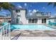 This house boasts a backyard pool, patio with furniture, balcony, and palm trees for relaxing outdoor living at 533 Lillian Dr, Madeira Beach, FL 33708