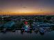 Sunset view of waterfront backyard with a private dock and boats, perfect for evening relaxation at 533 Lillian Dr, Madeira Beach, FL 33708
