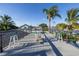 Large rooftop deck featuring outdoor bar seating, tropical landscaping, and space for entertaining on a bright, sunny day at 533 Lillian Dr, Madeira Beach, FL 33708