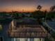 A rooftop deck is illuminated by string lights for an evening gathering at 533 Lillian Dr, Madeira Beach, FL 33708
