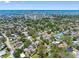 Scenic aerial view captures residential neighborhood with lush trees and city skyline near the water at 568 La Plaza S Ave, St Petersburg, FL 33707