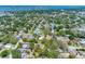 Wide aerial showcases a residential area with lush trees and city skyline near bay at 568 La Plaza S Ave, St Petersburg, FL 33707