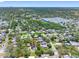 Wide aerial of a residential area with lush trees and cityscape in the distance at 568 La Plaza S Ave, St Petersburg, FL 33707
