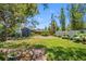 Expansive backyard featuring a charming shed, privacy fence, mature trees, and ample green space for outdoor activities at 568 La Plaza S Ave, St Petersburg, FL 33707