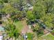 A spacious fenced backyard featuring mature trees and storage sheds providing ample space and privacy at 568 La Plaza S Ave, St Petersburg, FL 33707