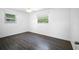 Bedroom with dark wood floors and large windows for natural light at 568 La Plaza S Ave, St Petersburg, FL 33707