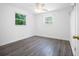 Bright bedroom with hardwood floors, two windows, ceiling fan and fresh, white paint at 568 La Plaza S Ave, St Petersburg, FL 33707