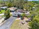 A charming single-story home features mature landscaping, a paved driveway, and inviting outdoor seating at 568 La Plaza S Ave, St Petersburg, FL 33707