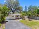 Charming single-story home featuring a paved driveway, lush landscaping, and inviting entryway at 568 La Plaza S Ave, St Petersburg, FL 33707
