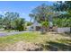 Inviting home with mature trees, lush landscaping, and a well-manicured lawn at 568 La Plaza S Ave, St Petersburg, FL 33707