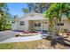 Charming single-story home with a well-maintained front yard, vibrant flowers and a cozy, covered entryway at 568 La Plaza S Ave, St Petersburg, FL 33707