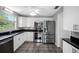 Updated kitchen featuring stainless steel appliances and white cabinets at 568 La Plaza S Ave, St Petersburg, FL 33707