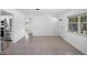 Bright living room with tile flooring, white walls, and ample natural light at 568 La Plaza S Ave, St Petersburg, FL 33707