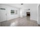 Bright living room showcasing neutral tile floors, a large front window, and an adjoining living area with a fireplace at 568 La Plaza S Ave, St Petersburg, FL 33707