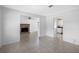Spacious living room featuring tile flooring, an exposed brick fireplace, and an open floor plan with natural light at 568 La Plaza S Ave, St Petersburg, FL 33707