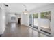 Spacious living room featuring tile flooring, an exposed brick fireplace, and sliding glass doors to the outdoors at 568 La Plaza S Ave, St Petersburg, FL 33707