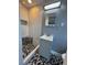 Updated bathroom featuring a gray vanity and a black and white tiled shower at 5800 Dartmouth N Ave, St Petersburg, FL 33710
