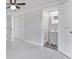Bedroom featuring white tile floors and an ensuite bathroom at 5800 Dartmouth N Ave, St Petersburg, FL 33710