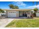 Welcoming front porch with neutral siding, stone accents, and cozy seating area at 5800 Dartmouth N Ave, St Petersburg, FL 33710