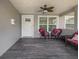 Covered front porch featuring wood-look tile flooring and a cozy seating area at 5800 Dartmouth N Ave, St Petersburg, FL 33710