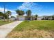Charming single-story home with a well-manicured lawn, driveway, and tropical landscaping at 5800 Dartmouth N Ave, St Petersburg, FL 33710
