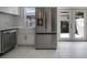 Kitchen featuring stainless steel appliances, white cabinets, and a large farmhouse sink at 5800 Dartmouth N Ave, St Petersburg, FL 33710