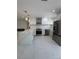 Modern kitchen featuring white cabinets, stainless steel appliances and quartz countertops at 5800 Dartmouth N Ave, St Petersburg, FL 33710