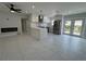 Open-concept living room features tile floors, modern fireplace, and eat-in kitchen with stainless appliances at 5800 Dartmouth N Ave, St Petersburg, FL 33710