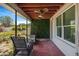 Covered patio with comfortable seating, a ceiling fan, and a view of the backyard at 5800 Dartmouth N Ave, St Petersburg, FL 33710