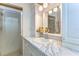 Bathroom featuring marble countertops, lighting, and shower at 5906 Greenbriar Ct, Zephyrhills, FL 33542