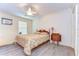 Bedroom with wood laminate flooring, ceiling fan, and one window at 5906 Greenbriar Ct, Zephyrhills, FL 33542