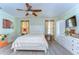 Bedroom featuring wood laminate floors, an ample closet and natural light at 5906 Greenbriar Ct, Zephyrhills, FL 33542