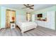 Large bedroom features wood laminate floors, an ample closet and natural light at 5906 Greenbriar Ct, Zephyrhills, FL 33542
