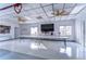 Well-lit clubhouse with ceiling fans, tables, and chairs arranged for community events at 5906 Greenbriar Ct, Zephyrhills, FL 33542
