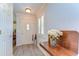 Bright entryway with laminate flooring, a shuttered window, and a wooden console table at 5906 Greenbriar Ct, Zephyrhills, FL 33542