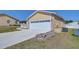 A charming home featuring an attached two-car garage and well-manicured front lawn at 5906 Greenbriar Ct, Zephyrhills, FL 33542
