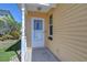 Charming front door with white trim, a glass storm door, and a small window for natural light at 5906 Greenbriar Ct, Zephyrhills, FL 33542