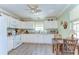 Cozy kitchen featuring white cabinets, laminate countertops, and a window with natural light at 5906 Greenbriar Ct, Zephyrhills, FL 33542