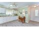 Inviting kitchen featuring white cabinets, a window over the sink, and laminate wood flooring at 5906 Greenbriar Ct, Zephyrhills, FL 33542