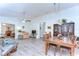 Spacious living area featuring laminate floors, neutral walls, and multiple seating areas at 5906 Greenbriar Ct, Zephyrhills, FL 33542