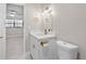 Bathroom featuring modern vanity with brass fixtures and an open view into the bedroom at 5980 80Th St N # 106, St Petersburg, FL 33709
