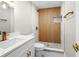 Stylish bathroom featuring a tiled shower with wood accent, quartz countertop, and gold fixtures at 5980 80Th St N # 106, St Petersburg, FL 33709