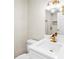 Bathroom features a white vanity, toilet, gold hardware, decorative lighting, and modern fixtures at 5980 80Th St N # 106, St Petersburg, FL 33709