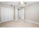 Spacious bedroom with fan and large closet, featuring neutral paint and tile floors at 5980 80Th St N # 106, St Petersburg, FL 33709