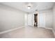Bright, empty bedroom with tile floors and a full bathroom, creating a modern and inviting space at 5980 80Th St N # 106, St Petersburg, FL 33709